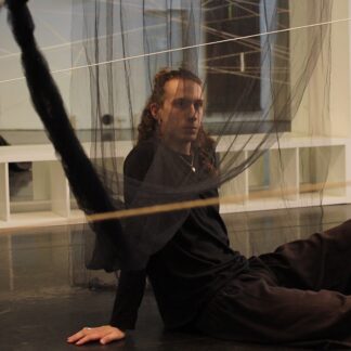 This picture shows teacher Octave in the dance studio behind a curtain