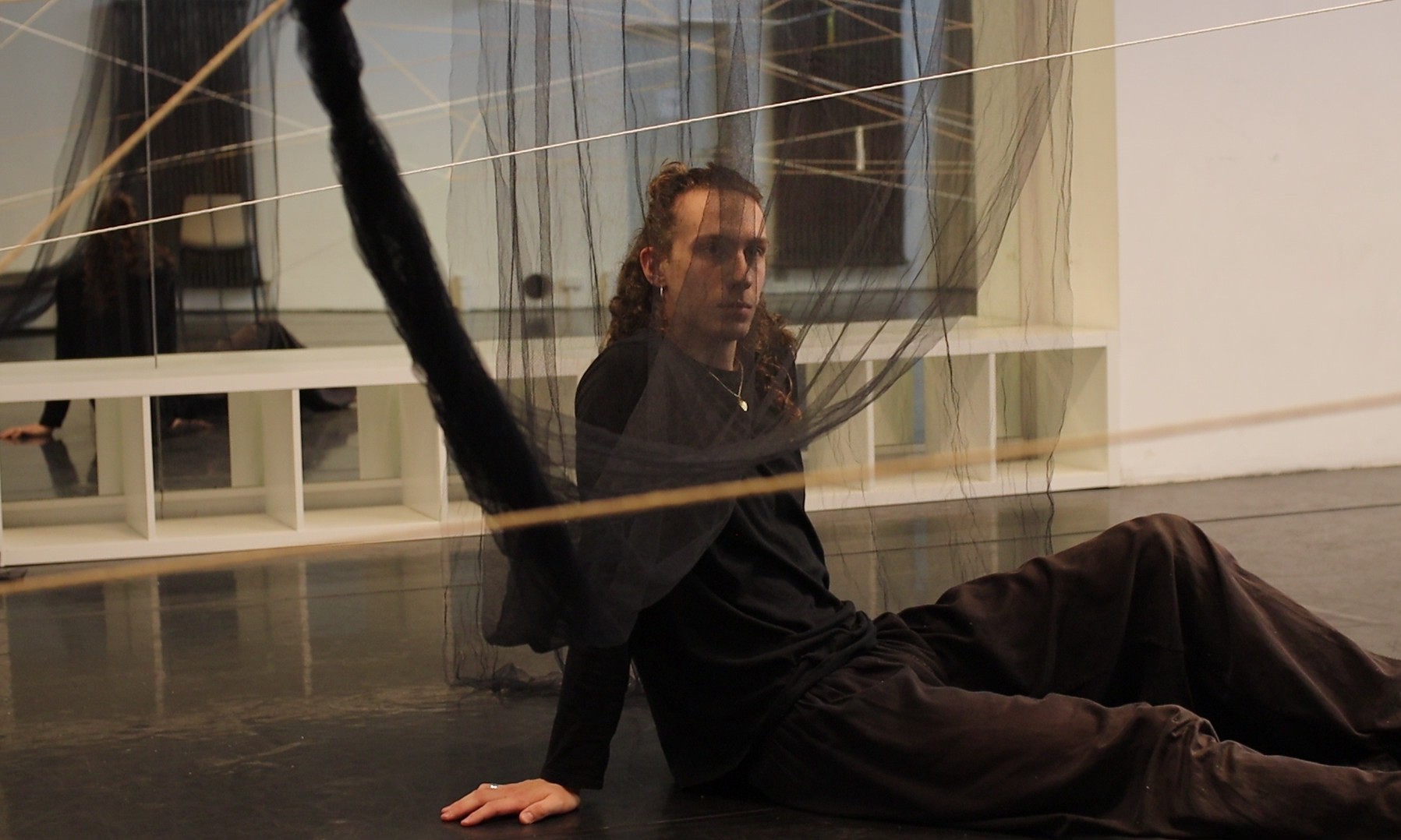 This picture shows teacher Octave in the dance studio behind a curtain