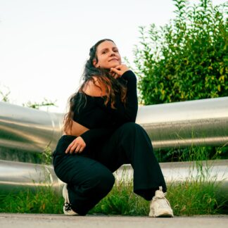 this picture shows an artist portrait of dance teacher Missa outside, posing for the camera