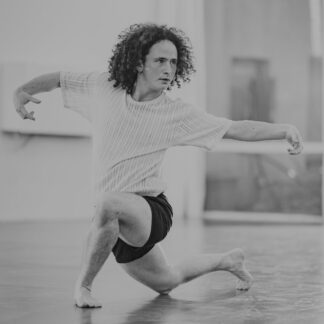 This picture shows a black-and-white photo of teacher Shira in the dance studio, dancing.